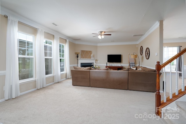 4915 Juniper Grove Ct SW, Concord, NC 28027 - carpeted living room featuring ceiling fan, plenty of natural light, crown molding, and stairway