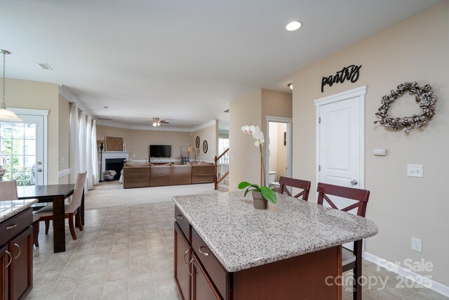 4915 Juniper Grove Ct SW, Concord, NC 28027 - kitchen featuring a kitchen breakfast bar, light stone counters, pendant lighting, dark brown cabinetry, and recessed lighting
