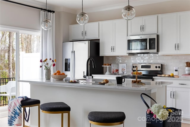 2238 Endeavor Run, Charlotte, NC 28269 - kitchen featuring stainless steel appliances, backsplash, light countertops, a breakfast bar, and white cabinets