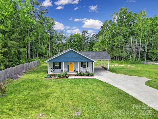 2302 Douglas Rd, Lancaster, SC 29720 - view of front of home with covered porch, concrete driveway, an attached carport, and a forest view