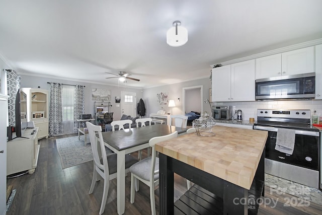 2302 Douglas Rd, Lancaster, SC 29720 - kitchen with appliances with stainless steel finishes, crown molding, ceiling fan, white cabinets, and backsplash