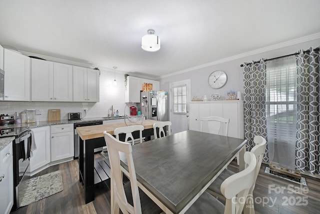 2302 Douglas Rd, Lancaster, SC 29720 - kitchen featuring stainless steel appliances, ornamental molding, decorative backsplash, dark wood-style floors, and white cabinets