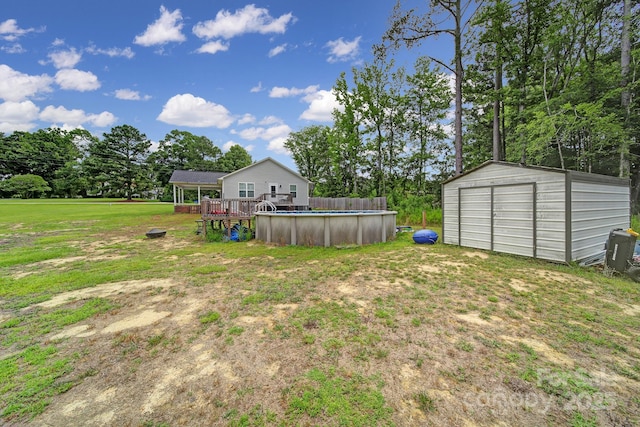 2302 Douglas Rd, Lancaster, SC 29720 - view of green lawn with a storage unit, an outdoor pool, a wooden deck, and view of scattered trees
