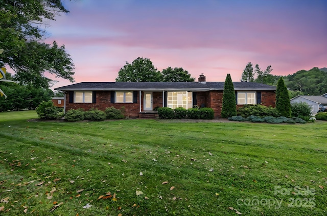 242 Pattys Chapel Rd, Fletcher, NC 28732 - ranch-style home with a chimney, a lawn, and brick siding