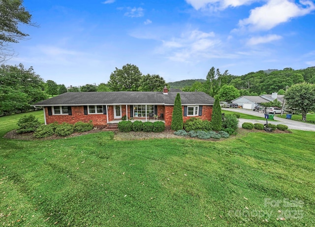 242 Pattys Chapel Rd, Fletcher, NC 28732 - single story home with a porch, brick siding, a front lawn, and a chimney