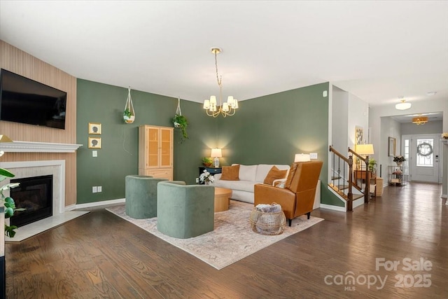 15515 Laverack Ln, Davidson, NC 28036 - living area with wood finished floors, a chandelier, stairway, and a fireplace
