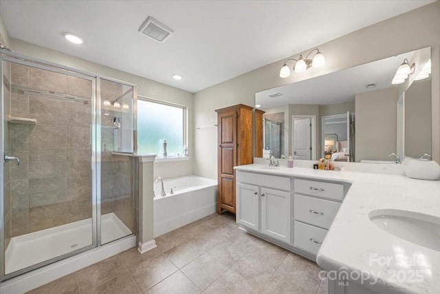 15515 Laverack Ln, Davidson, NC 28036 - bathroom featuring double vanity, a garden tub, a stall shower, tile patterned flooring, and recessed lighting