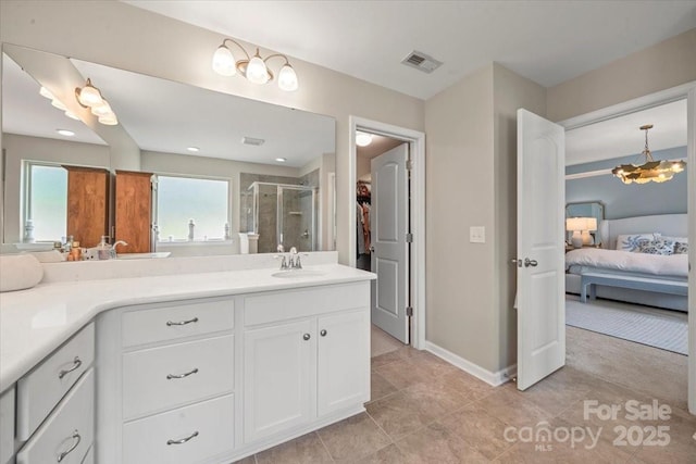 15515 Laverack Ln, Davidson, NC 28036 - ensuite bathroom featuring vanity, a shower stall, a walk in closet, tile patterned flooring, and a chandelier