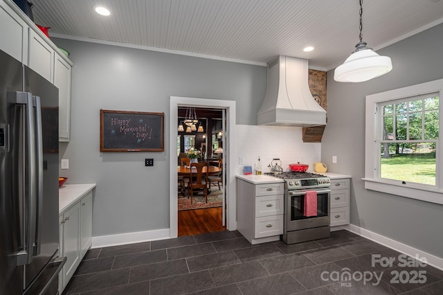 409 S Grove St, Lincolnton, NC 28092 - kitchen with stainless steel range with gas stovetop, freestanding refrigerator, custom exhaust hood, light countertops, and recessed lighting