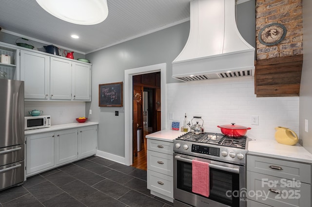 409 S Grove St, Lincolnton, NC 28092 - kitchen with appliances with stainless steel finishes, custom exhaust hood, open shelves, light countertops, and decorative backsplash