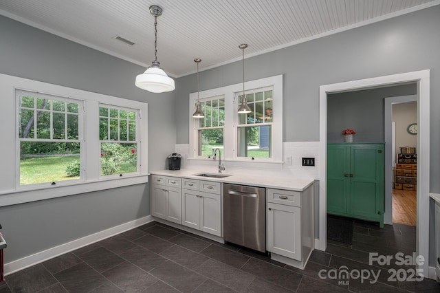 409 S Grove St, Lincolnton, NC 28092 - kitchen with stainless steel dishwasher, a sink, light countertops, decorative light fixtures, and decorative backsplash
