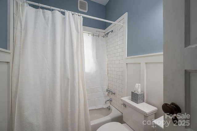 409 S Grove St, Lincolnton, NC 28092 - bathroom with toilet, shower / bathtub combination with curtain, and a wainscoted wall
