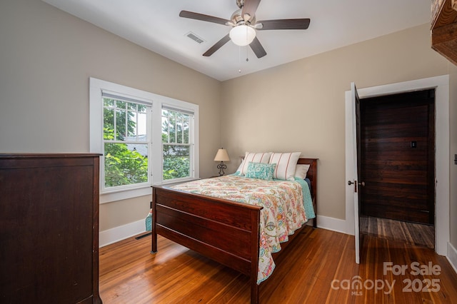 409 S Grove St, Lincolnton, NC 28092 - bedroom featuring hardwood / wood-style floors, baseboards, and a ceiling fan