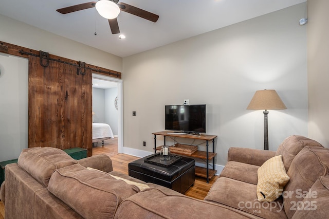 409 S Grove St, Lincolnton, NC 28092 - living room with a barn door, light wood-style floors, a ceiling fan, baseboards, and recessed lighting