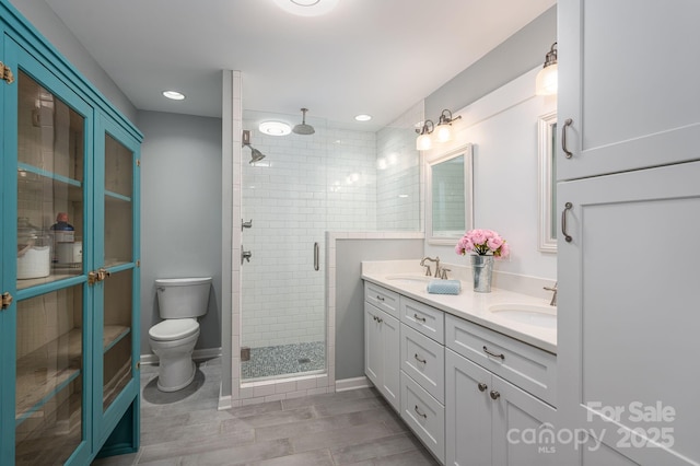 409 S Grove St, Lincolnton, NC 28092 - bathroom with a shower stall, double vanity, toilet, recessed lighting, and baseboards