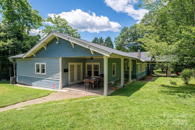 409 S Grove St, Lincolnton, NC 28092 - back of property with a ceiling fan, a lawn, a chimney, and a patio area
