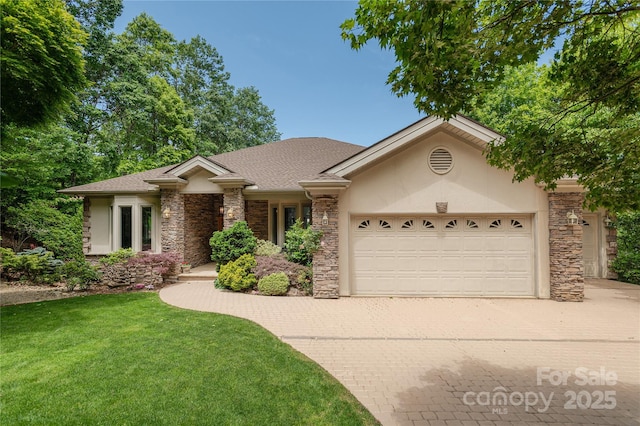 201 Kawani Ln, Brevard, NC 28712 - view of front facade with stone siding, an attached garage, decorative driveway, a front lawn, and stucco siding