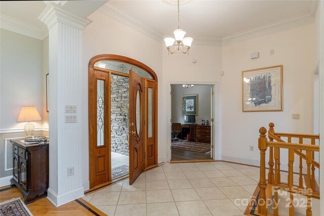 201 Kawani Ln, Brevard, NC 28712 - entryway featuring ornamental molding, a chandelier, baseboards, decorative columns, and light tile patterned floors