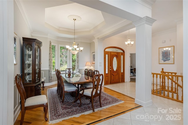 201 Kawani Ln, Brevard, NC 28712 - dining room with decorative columns, a chandelier, light tile patterned flooring, and crown molding