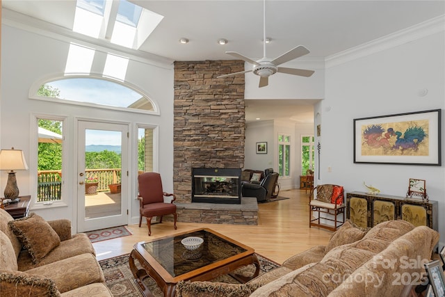 201 Kawani Ln, Brevard, NC 28712 - living room featuring ornamental molding, ceiling fan, wood finished floors, plenty of natural light, and a stone fireplace