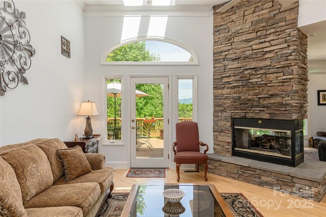 201 Kawani Ln, Brevard, NC 28712 - living room with wood finished floors, healthy amount of natural light, crown molding, a fireplace, and a high ceiling