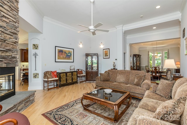 201 Kawani Ln, Brevard, NC 28712 - living room with a ceiling fan, ornamental molding, a stone fireplace, light wood-type flooring, and a chandelier