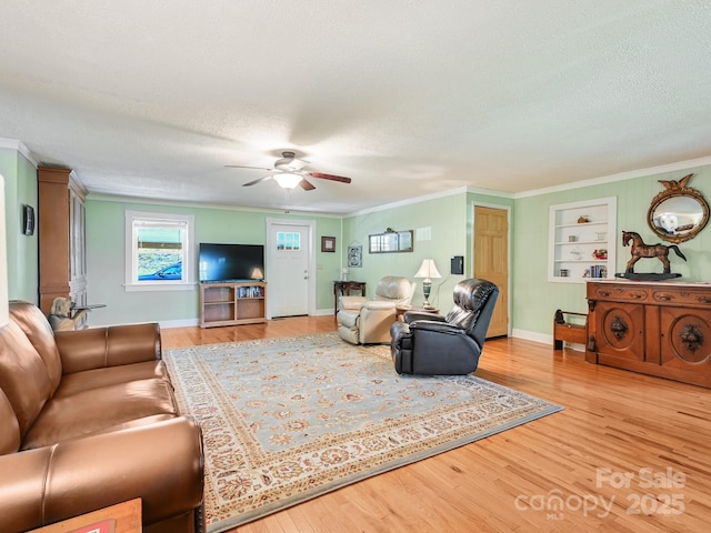 90 Coates Rd, Marshall, NC 28753 - living area with ornamental molding, a ceiling fan, a textured ceiling, wood finished floors, and built in shelves