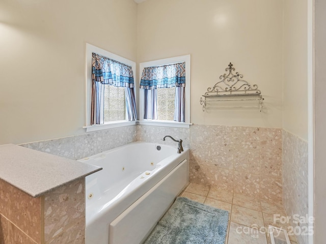 90 Coates Rd, Marshall, NC 28753 - bathroom with a jetted tub, tile patterned floors, a wainscoted wall, and tile walls
