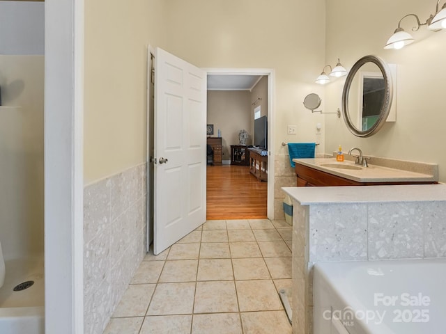 90 Coates Rd, Marshall, NC 28753 - bathroom featuring tile patterned floors, vanity, tile walls, ensuite bathroom, and a wainscoted wall