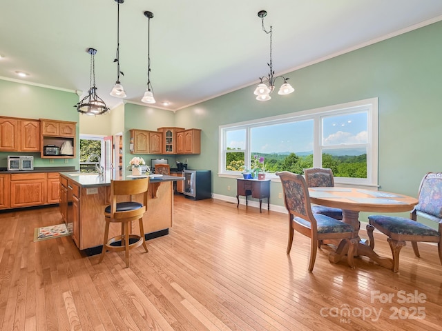 90 Coates Rd, Marshall, NC 28753 - kitchen featuring crown molding, a kitchen island, healthy amount of natural light, and light wood-style flooring