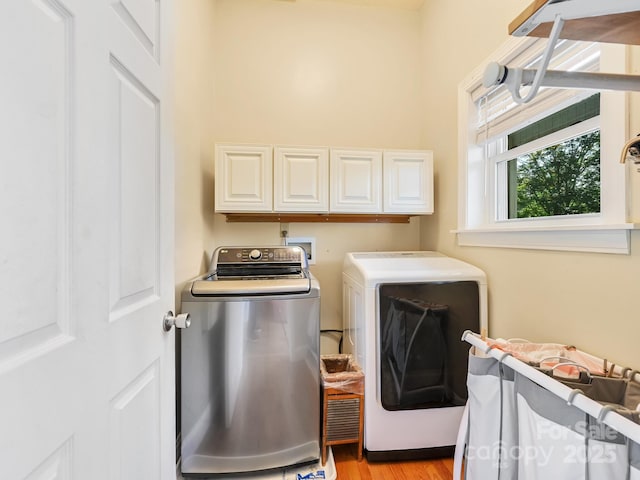 90 Coates Rd, Marshall, NC 28753 - washroom featuring cabinet space, washer and dryer, and light wood-type flooring