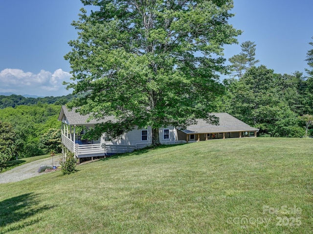 90 Coates Rd, Marshall, NC 28753 - view of front facade with a front lawn, a forest view, and roof with shingles