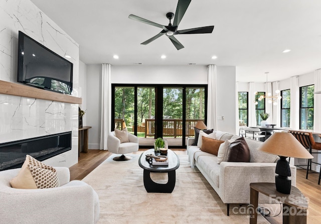 1626 Burtonwood Cir, Charlotte, NC 28212 - living room with light wood-type flooring, a fireplace, recessed lighting, and a ceiling fan