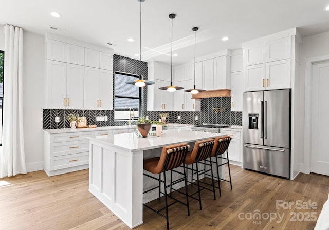 1626 Burtonwood Cir, Charlotte, NC 28212 - kitchen featuring high end fridge, backsplash, light wood finished floors, and recessed lighting