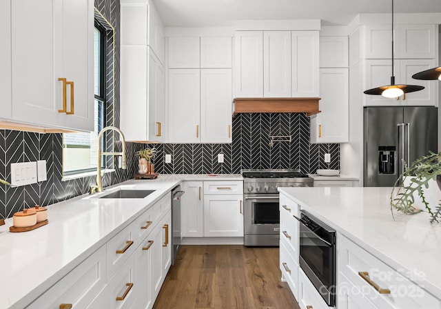 1626 Burtonwood Cir, Charlotte, NC 28212 - kitchen featuring premium appliances, white cabinets, light countertops, dark wood-style flooring, and decorative backsplash