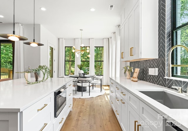 1626 Burtonwood Cir, Charlotte, NC 28212 - kitchen with appliances with stainless steel finishes, decorative backsplash, light countertops, recessed lighting, and white cabinetry