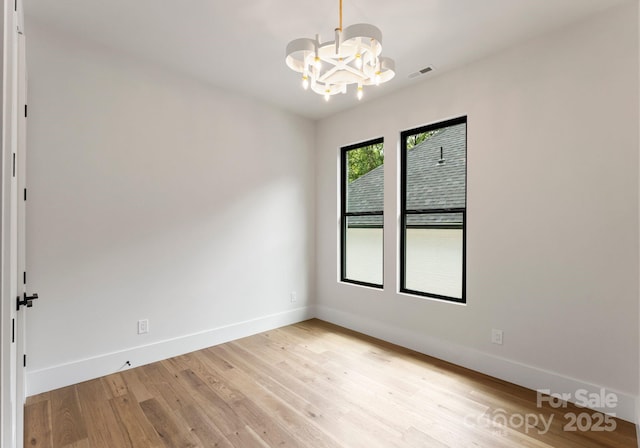 1626 Burtonwood Cir, Charlotte, NC 28212 - unfurnished room with a chandelier and light wood-style flooring