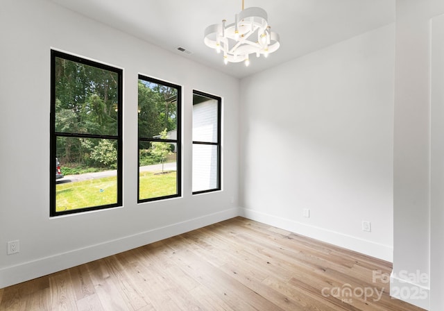 1626 Burtonwood Cir, Charlotte, NC 28212 - unfurnished room featuring a chandelier and light wood-style flooring