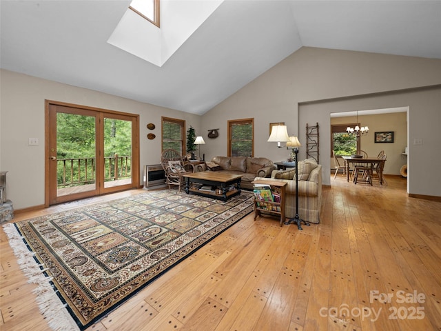 1396 W Christy Trl, Sapphire, NC 28774 - living area featuring a chandelier, light wood finished floors, high vaulted ceiling, and a skylight