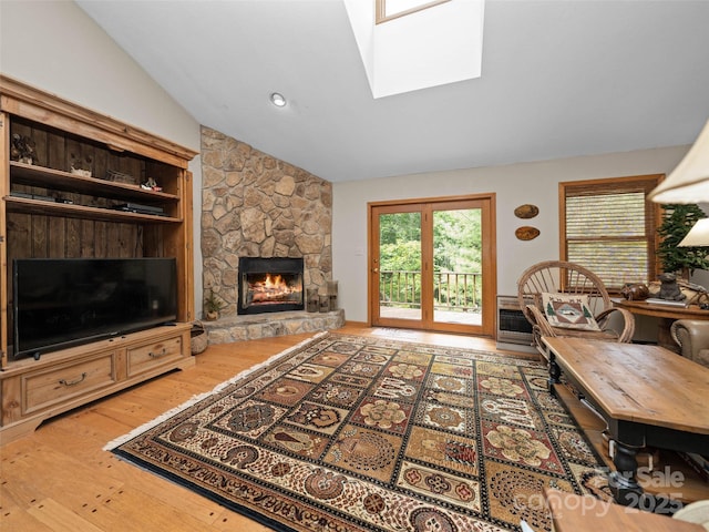 1396 W Christy Trl, Sapphire, NC 28774 - living room with a fireplace, hardwood / wood-style flooring, vaulted ceiling, and a skylight