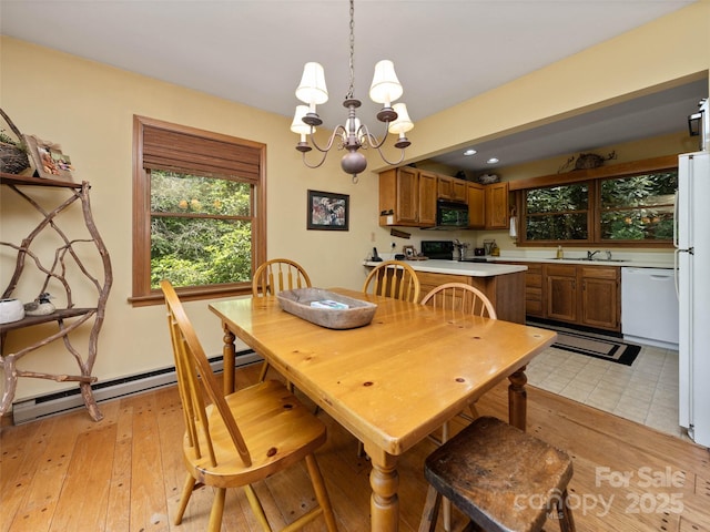 1396 W Christy Trl, Sapphire, NC 28774 - dining space with a chandelier, baseboard heating, and light wood-style floors