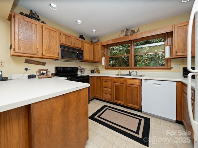 1396 W Christy Trl, Sapphire, NC 28774 - kitchen with black appliances, light countertops, recessed lighting, and brown cabinets