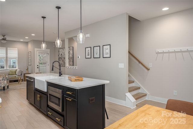 2011 Hamorton Pl, Charlotte, NC 28205 - kitchen featuring a sink, appliances with stainless steel finishes, light wood-type flooring, recessed lighting, and dark cabinetry