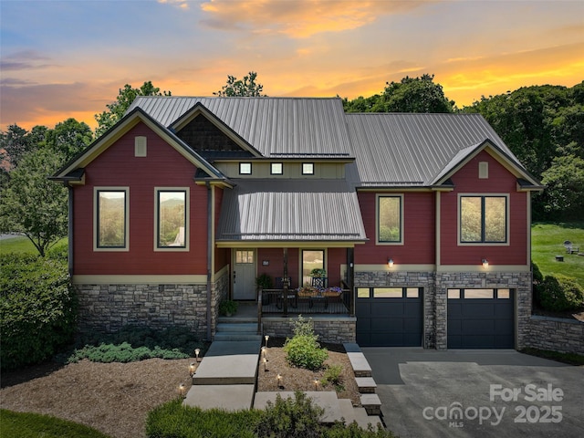 15 Carl Roberts Rd, Alexander, NC 28701 - view of front facade featuring stone siding, covered porch, a garage, concrete driveway, and metal roof