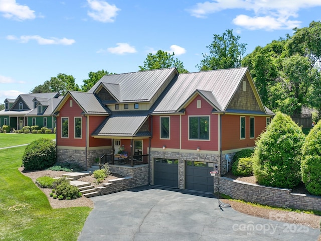 15 Carl Roberts Rd, Alexander, NC 28701 - view of front of home with stone siding, an attached garage, driveway, a front yard, and metal roof