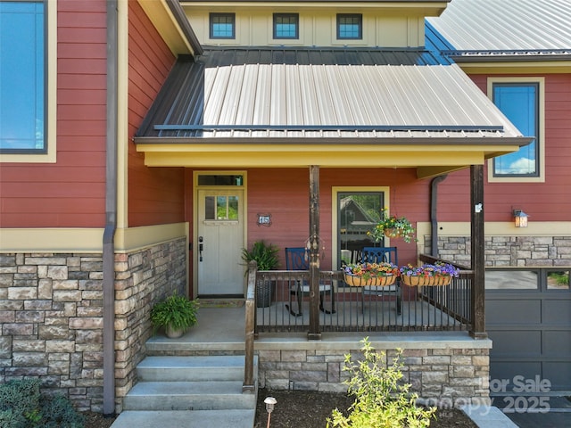 15 Carl Roberts Rd, Alexander, NC 28701 - view of exterior entry with covered porch, stone siding, and metal roof