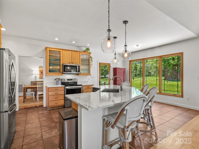 15 Carl Roberts Rd, Alexander, NC 28701 - kitchen featuring stainless steel appliances, a sink, a kitchen breakfast bar, an island with sink, and dark tile patterned floors