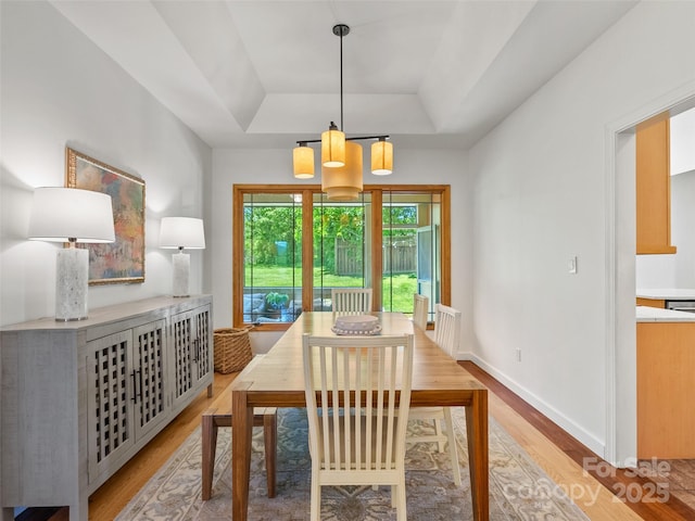 15 Carl Roberts Rd, Alexander, NC 28701 - dining area with a tray ceiling, light wood-type flooring, baseboards, and a chandelier