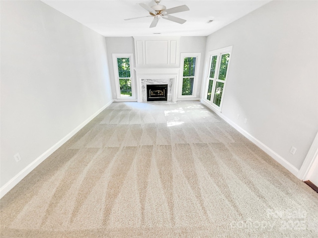 8803 Sweetwater Pl, Waxhaw, NC 28173 - unfurnished living room featuring healthy amount of natural light, light colored carpet, baseboards, and a ceiling fan