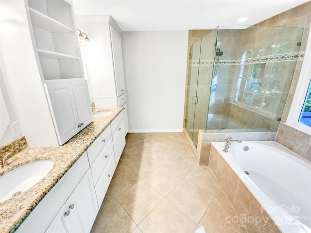 8803 Sweetwater Pl, Waxhaw, NC 28173 - bathroom featuring double vanity, a stall shower, a bath, tile patterned flooring, and baseboards